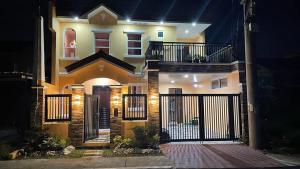 a house with a gate in front of it at night at Silang Guest house in Bangkal