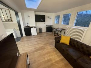 a living room with a couch and a table at Calais Wilson 2 - Studio Balneo 2p in Calais