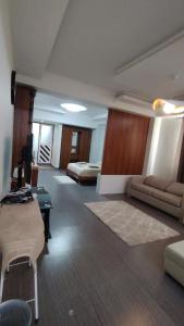 a large living room with a couch and a bed at Seabeach residence in Belle Mare