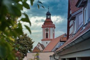 a building with a clock tower on top of it at RefuKium alte Gerberei - Im Zentrum von Weißenburg in Weißenburg in Bayern