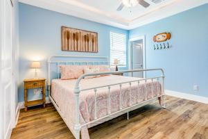 a bedroom with a bed and a blue wall at Paradise Steps to Beach Large Deck Dog Haven in Crystal Beach