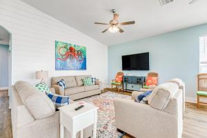 a living room with two couches and a flat screen tv at Paradise Steps to Beach Large Deck Dog Haven in Crystal Beach