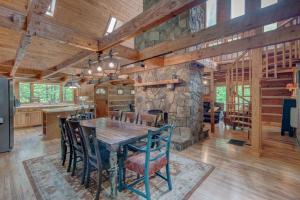 a dining room with a table and a stone wall at Hidden Creek Cabin in Fleetwood