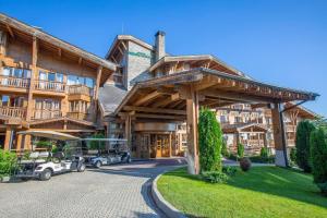 a large building with cars parked in front of it at Emily Pirin Golf in Razlog
