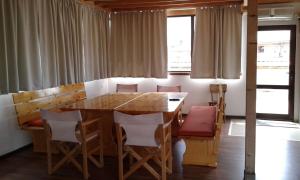 a dining room with a wooden table and chairs at Къща за гости Семейство Петрови in Kalofer