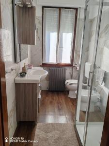 a bathroom with a sink and a toilet at Casa TERESINA in Ardenno +15 photos