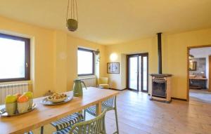 a living room with a table and chairs and a kitchen at House in the Shambhalla Forest in Esmate
