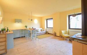 a kitchen and living room with a table and chairs at House in the Shambhalla Forest in Esmate