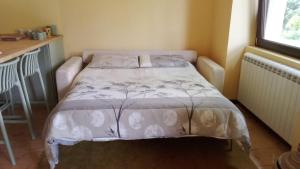 a bedroom with a bed with a white comforter at House in the Shambhalla Forest in Esmate +11 photos