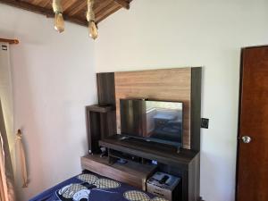 a flat screen tv sitting on a stand in a room at Finca santa helena in Machetá