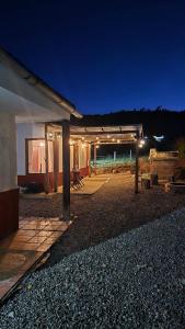 a house with a lit up patio at night at Finca santa helena in Machetá
