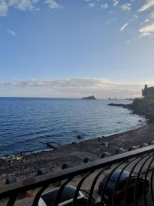 a view of a beach with the ocean at Al borgo di capomulini in Acireale