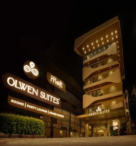 a building with lights on it at night at Olwen Suites in Cochin