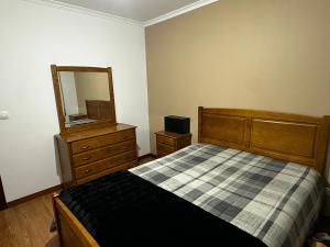 Ένα ή περισσότερα κρεβάτια σε δωμάτιο στο Apartamento Jardim do Sol