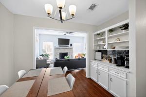 a dining room with a table and a living room at Vibrant 3BR Dallas Home, Near DFW, With Family-Friendly Amenities in Irving