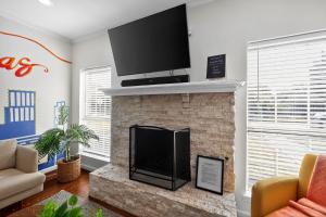 a living room with a fireplace with a flat screen tv at Vibrant 3BR Dallas Home, Near DFW, With Family-Friendly Amenities in Irving