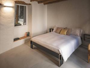 a bedroom with a large bed in a room at Casa Sorel : Attico Lago & Pool in Pianello Del Lario