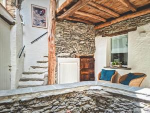 a stone staircase in a room with a stone wall at Casa Sorel : Attico Lago & Pool in Pianello Del Lario +41 photos