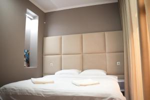 a bedroom with a large bed with two white pillows at Elata Aparts in Skhidnitsa