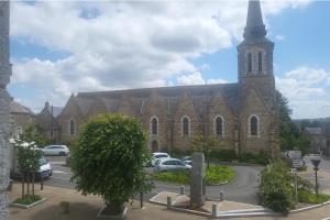 a large brick church with a clock tower at 1Bed Apartment Sleeps 2 - Parking Wifi in Fougerolles-du-Plessis