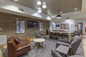 a waiting room with a table and chairs at Candlewood Suites San Marcos by IHG in San Marcos