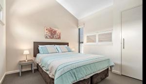 a bedroom with a large bed and a window at Beach Shack 6 in Preston Beach