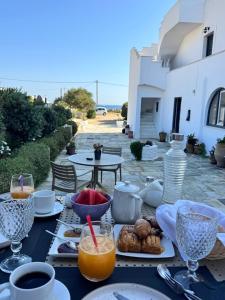 a table with plates of food and glasses of orange juice at Delight Apartments suites in Stelida