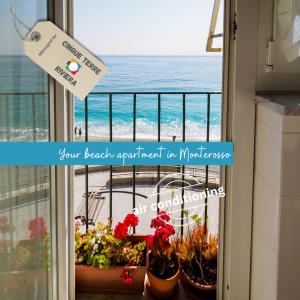a view of the ocean from a balcony with plants at Giaella Sea View Apartment in Monterosso al Mare