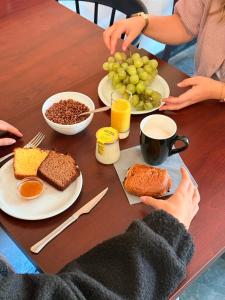 two people sitting at a table with plates of food at Kyriad Hotel Dijon Gare in Dijon