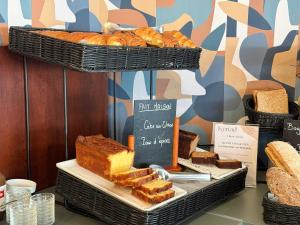 a display of bread and pastries in a bakery at Kyriad Hotel Dijon Gare in Dijon +46 photos