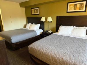 a hotel room with two beds and a telephone at Cozy Inn in Centralia