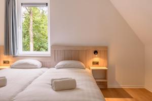 Postel nebo postele na pokoji v ubytování Dormio Resort De Hondsrug + 69 fotografií