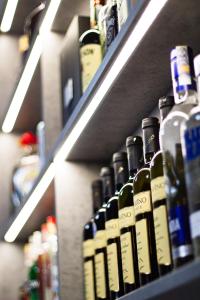a row of wine bottles on shelves in a store at Wellness Hotel Edelweiss in Liberec +39 photos
