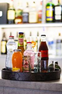 a tray filled with different types of drinks on a shelf at Wellness Hotel Edelweiss in Liberec +57 photos