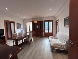 a living room with a table and a dining room at Dimore di Sant'Albino Montepulciano in Sant'Albino