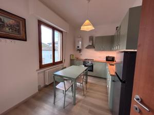 a kitchen with a table and a small table and chairs at Dimore di Sant'Albino Montepulciano in Sant'Albino