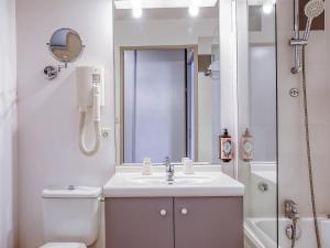 a bathroom with a toilet and a sink and a shower at Séjours & Affaires Angers Atrium in Angers +17 photos