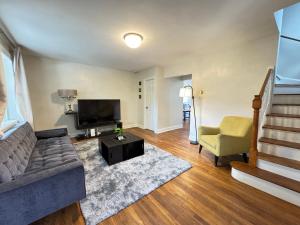 a living room with a couch and a television at Spacious Cozy Entire House in DC in Washington