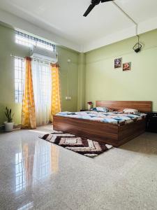 a bedroom with a large bed in a room at Aalohee Homestay in Guwahati +7 photos