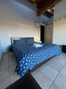 - une chambre avec un grand lit bleu dans l'établissement IL Borgo, à Modène