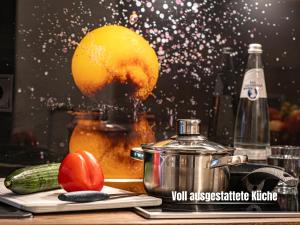 a kitchen counter with a juicer and a cutting board with a juicer at City Apartment Riesa in Riesa +9 photos
