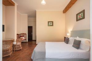 Ένα ή περισσότερα κρεβάτια σε δωμάτιο στο Casa da Fajã Alta