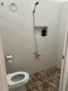 a bathroom with a toilet and a shower at Private VIP Tent in the Desert in Ḩawīyah