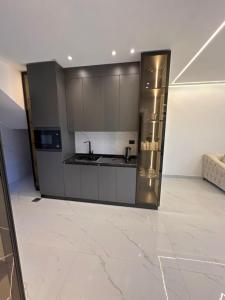 a kitchen with a stainless steel refrigerator in a room at las vegas villa in Ath Thughrah