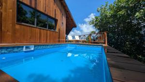 a swimming pool in front of a house at Turtle Beach Hotel Calibishie in Woodford Hill +31 photos