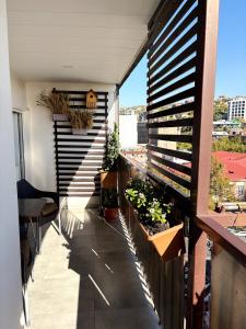 a balcony with plants and stairs on a building at Lily`s Loft in Yerevan