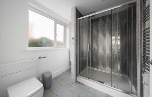 a bathroom with a glass shower and a toilet at Spacious city centre Flat in the heart of Chester in Chester