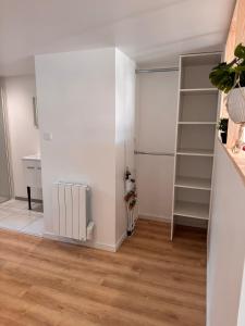 a room with white walls and a book shelf at Studio pour 2 personnes in Challans
