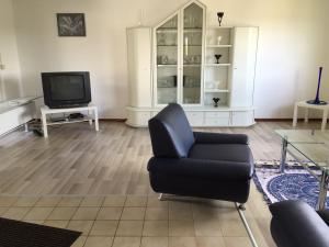 a living room with a chair and a television at Haus Elvira in Horb am Neckar