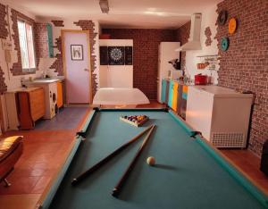 a room with a pool table in a kitchen at La Casita de Colmenar in Villaconejos